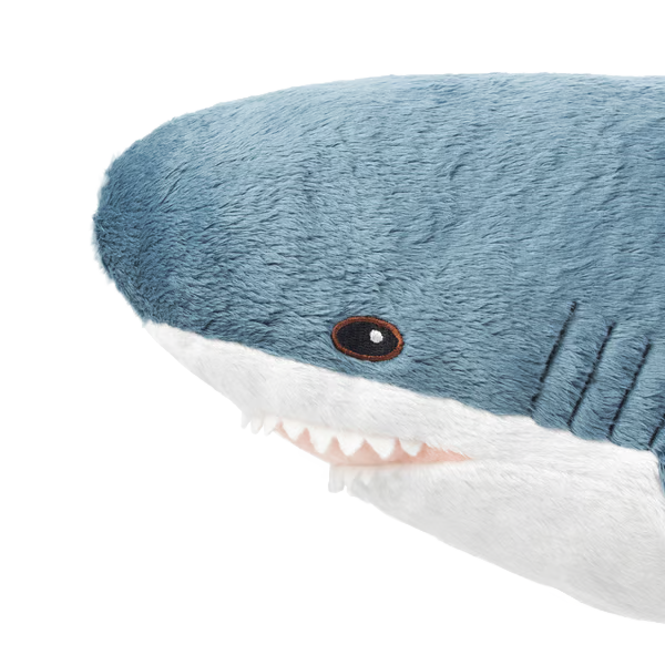 a blåhaj plushie. just the head, facing left